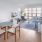 a room with a table chairs and a window