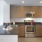 a kitchen with a stainless steel refrigerator