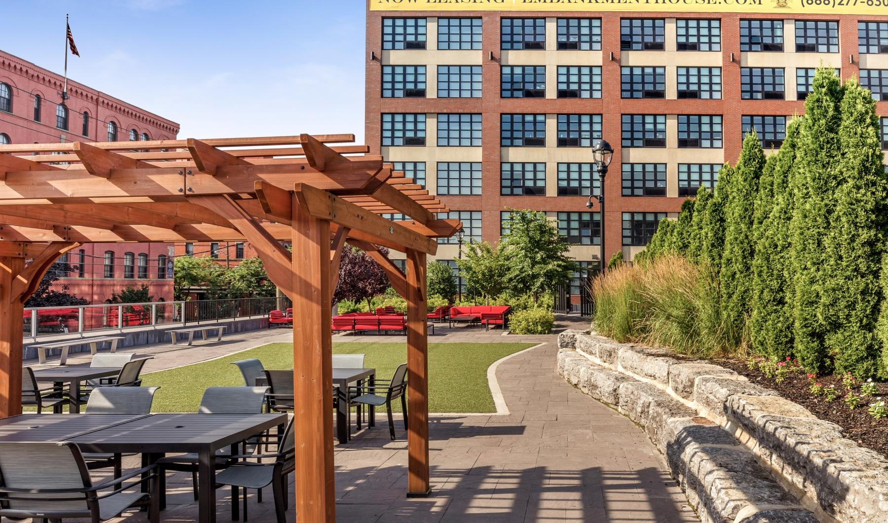 Find your perfect fit at Embankment House & Revetment House a patio with tables and chairs outside of a building
